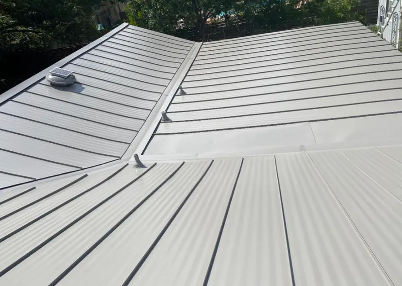 Solar attic fan installed on a metal roof for Roof Ventilation in Groveland